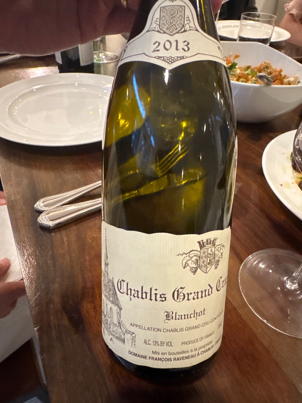 A bottle of 2013 Raveneau Chablis Grand Cru Blanchot on a dinner table